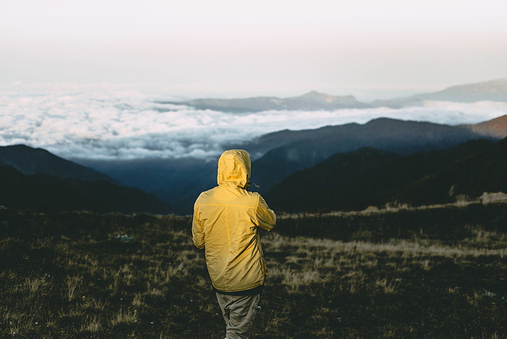 Caucasian man standing in remote mountain landscape