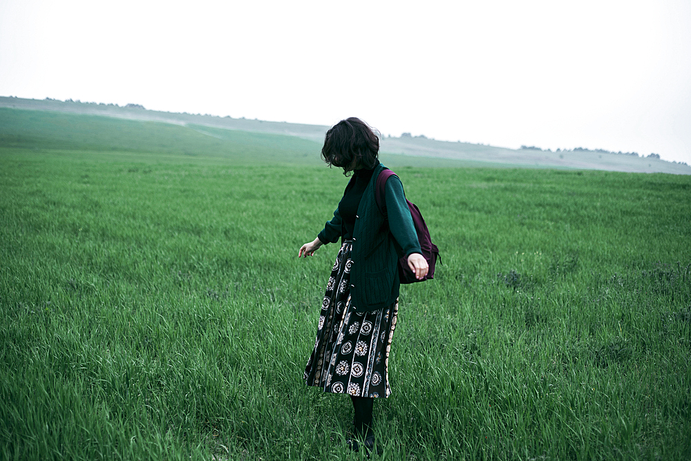 Caucasian woman standing in field of grass