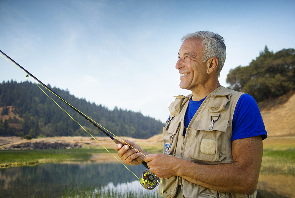 Caucasian man fishing at river