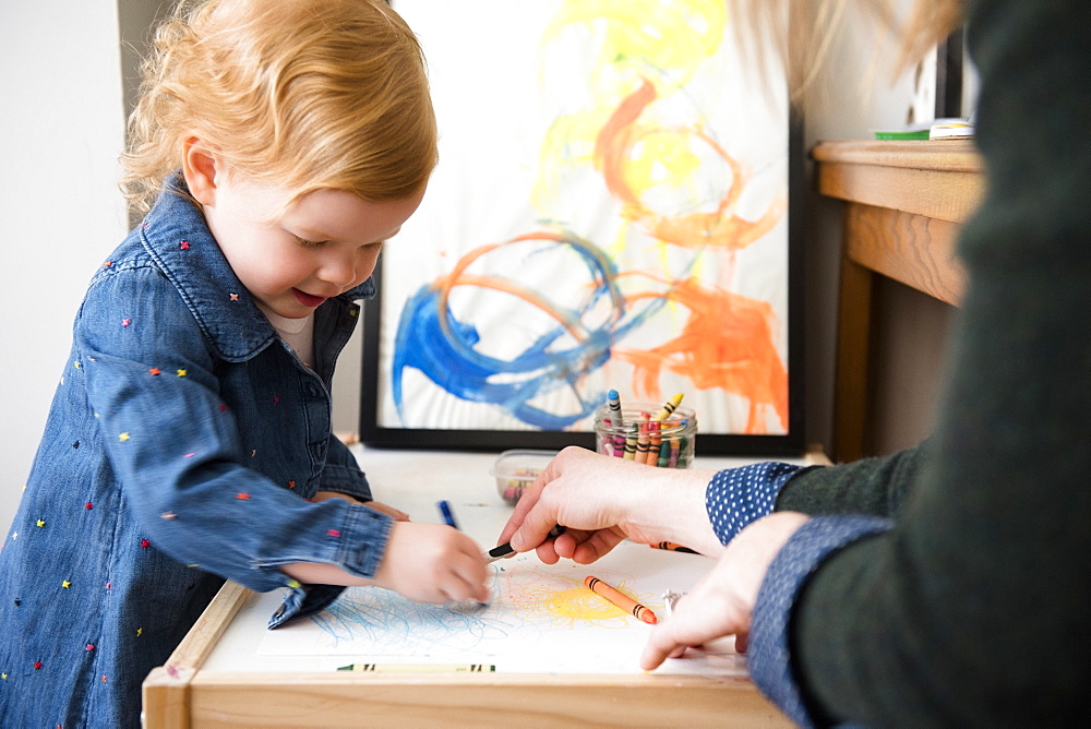 Caucasian mother and daughter coloring