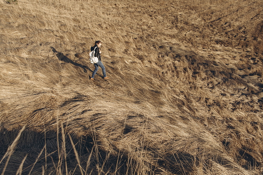 Middle Eastern woman walking on hill