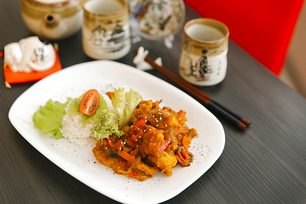 Chopsticks near plate of food