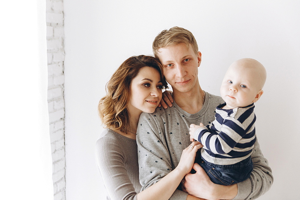 Portrait of smiling Caucasian mother and father with baby son