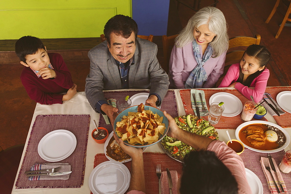 High angle view of family enjoying dinner in restaurant