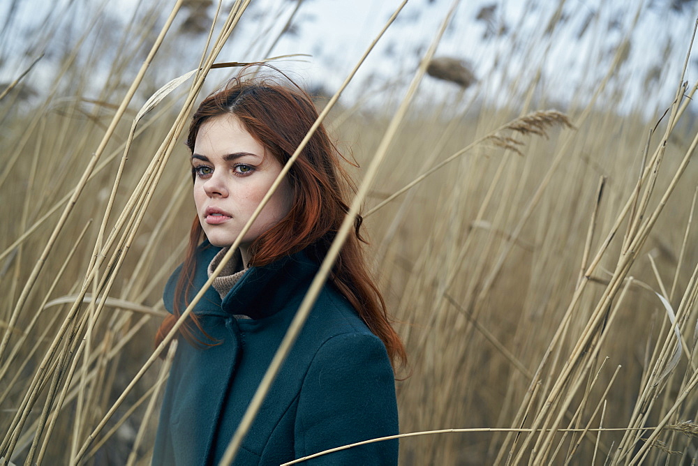 Portrait of serious Caucasian woman standing in field