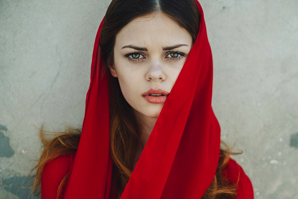 Serious Caucasian woman wearing red headscarf