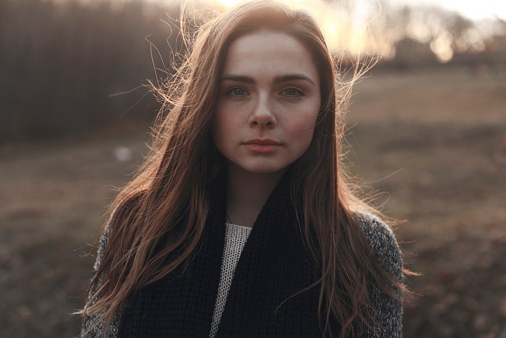 Portrait of serious Caucasian woman with hair blowing in wind