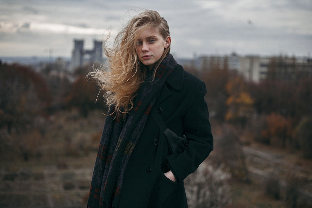 Portrait of Caucasian woman with hair blowing in wind