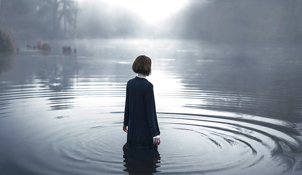 Woman wading in rippling river