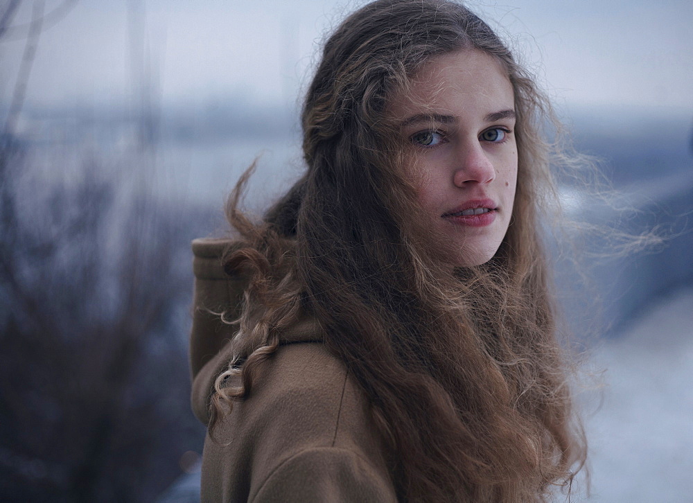 Portrait of wind blowing hair of serious Caucasian teenage girl