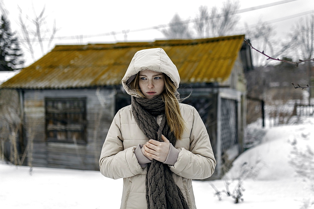 Caucasian woman wearing coat and scarf in winter