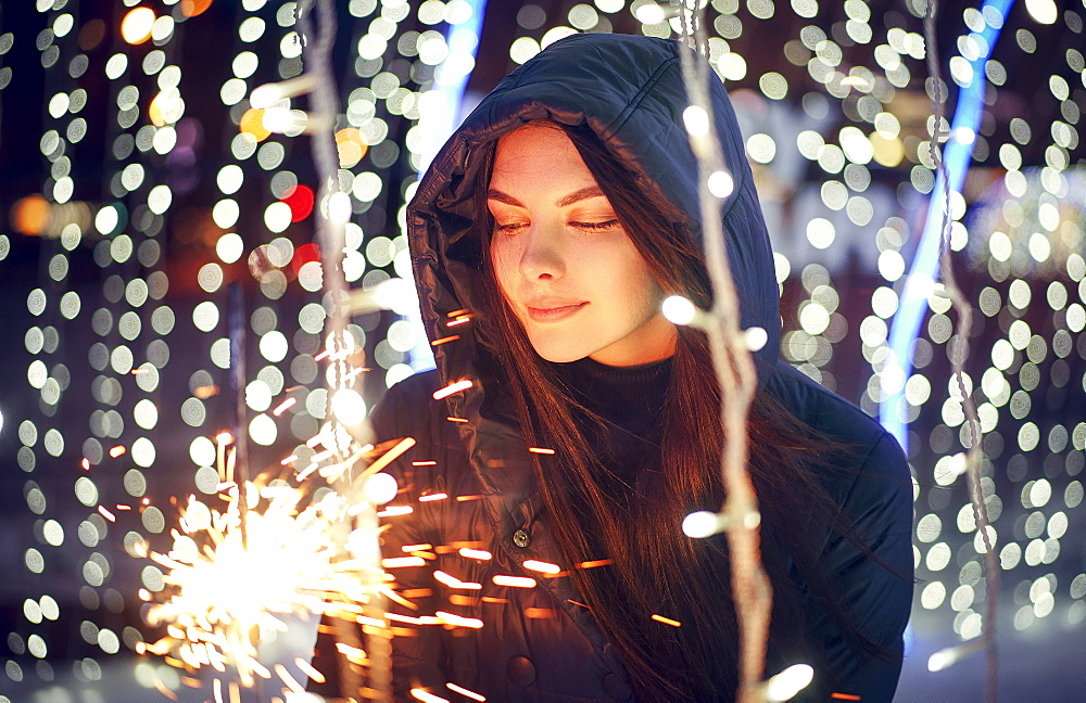 Caucasian woman holding sparkler