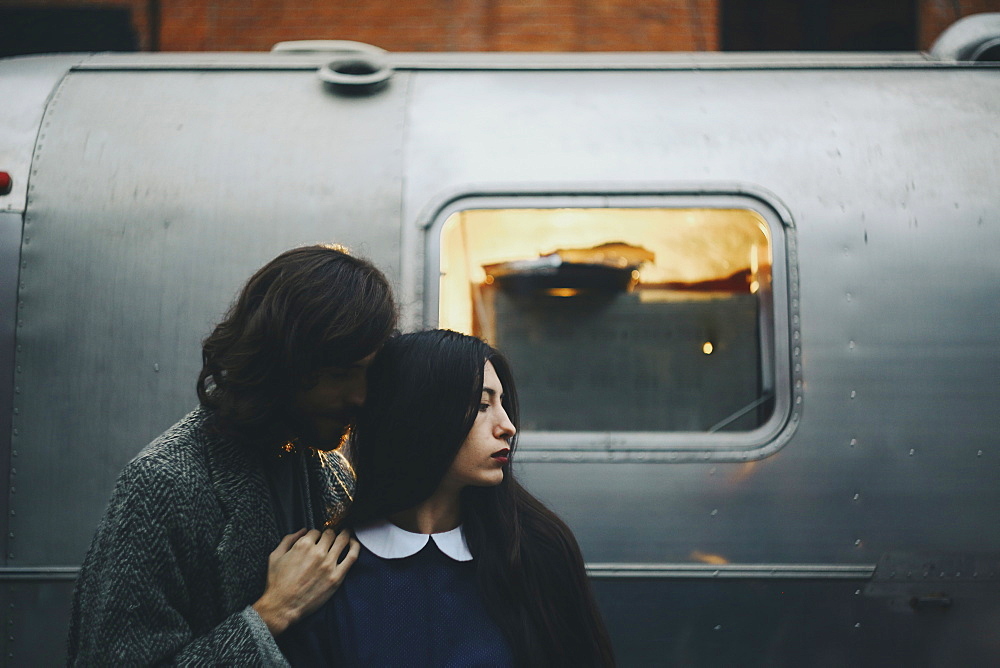 Caucasian couple near metal container