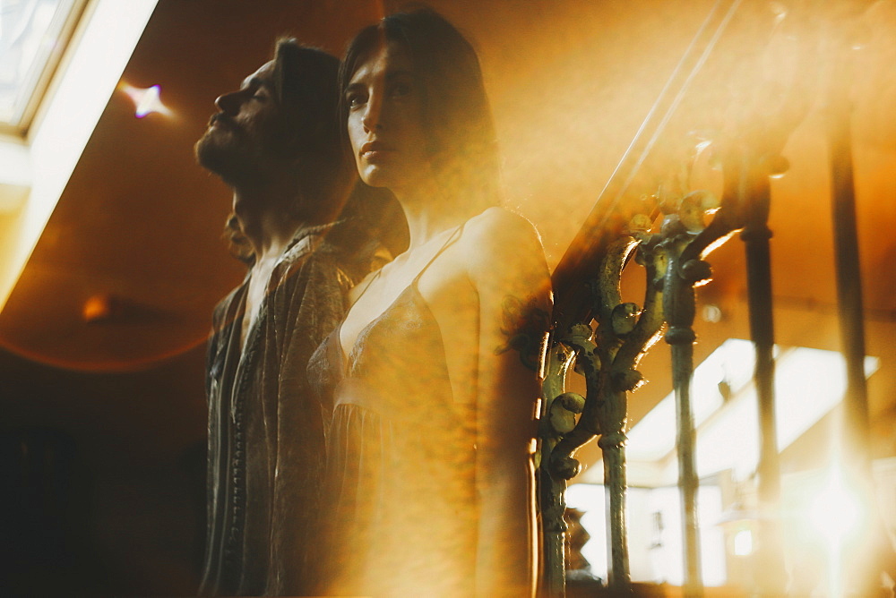 Double exposure of Caucasian couple and railing