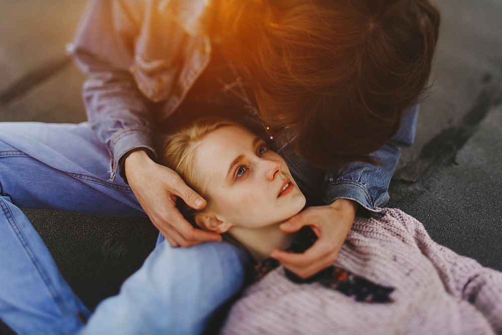 Caucasian woman laying in lap of man