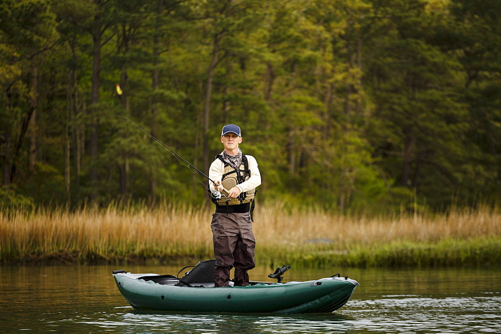 Caucasian man fishing on kayak