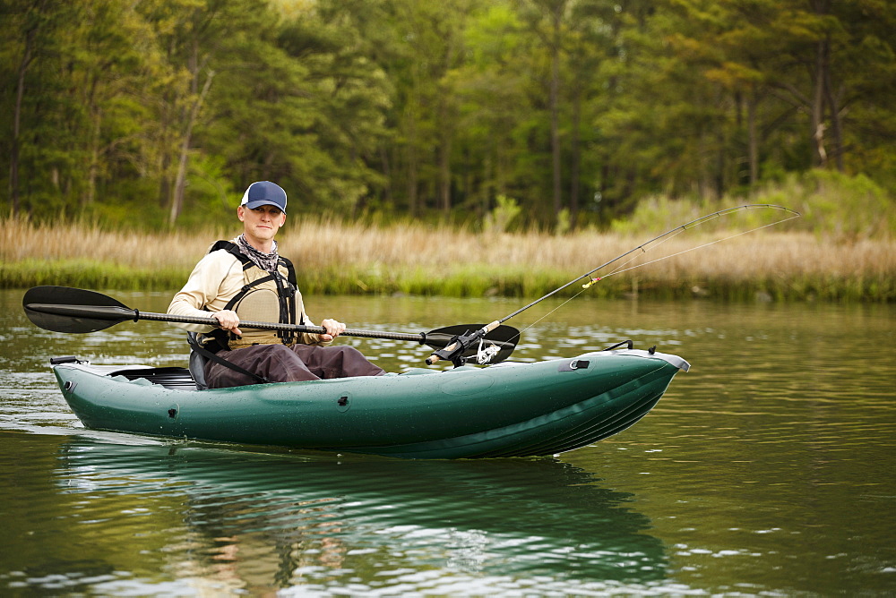 Caucasian man fishing on kayak