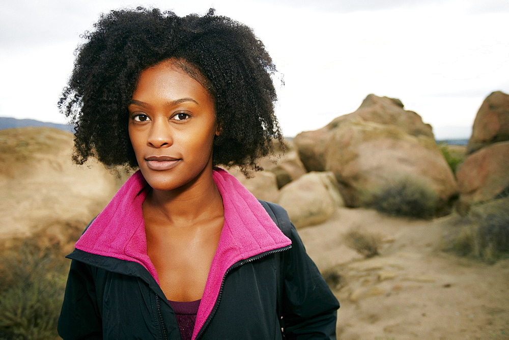 Portrait of serious Black woman posing on rock formation