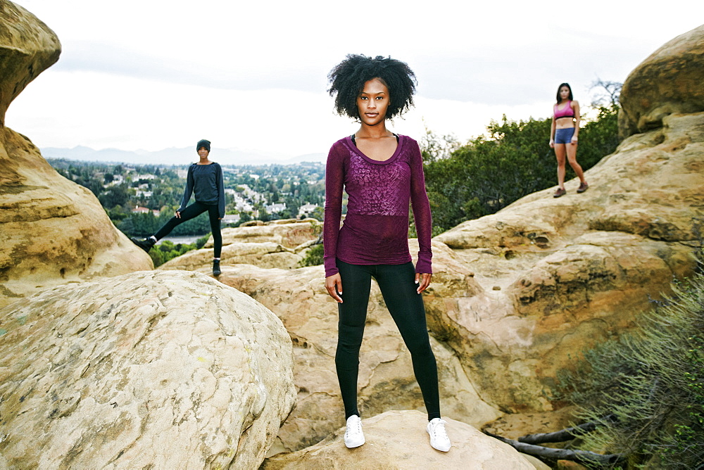 Portrait of serious women posing on rock formation