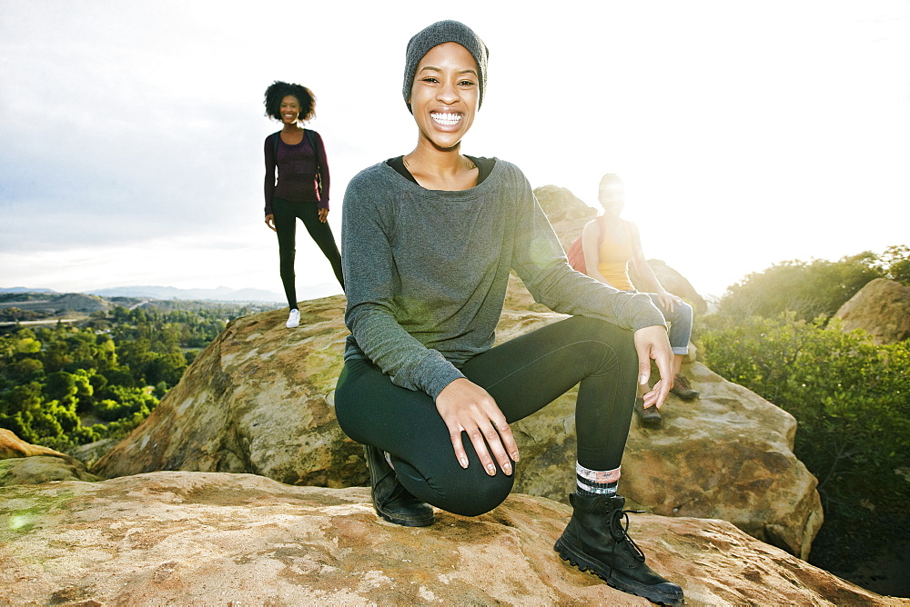 Portrait of smiling women posing on rock formation