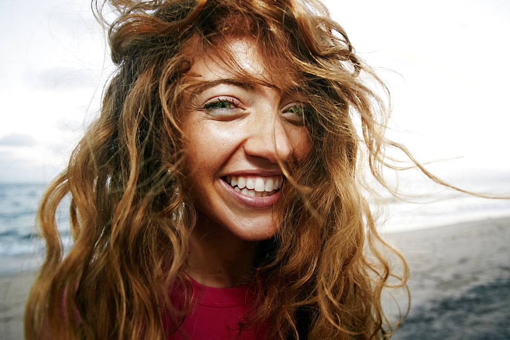 Wind blowing hair of Caucasian woman on beach