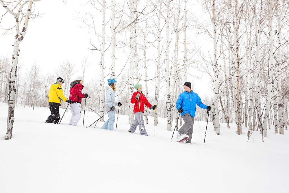 Caucasian family snowshoeing