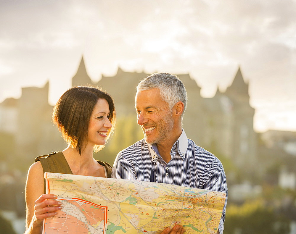 Caucasian couple reading map