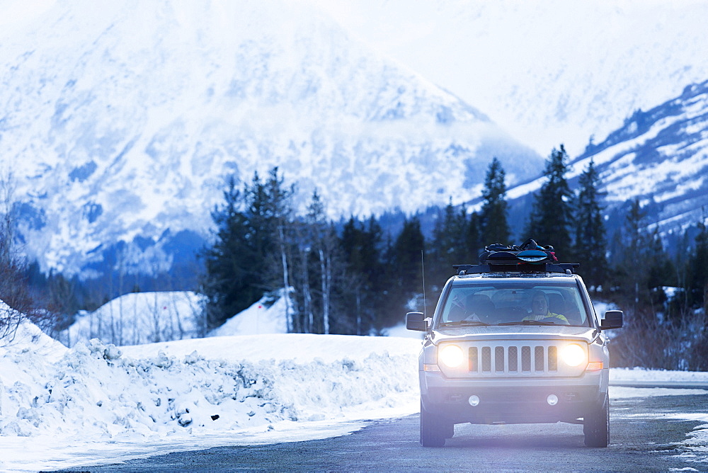 Headlights shining from car driving in winter