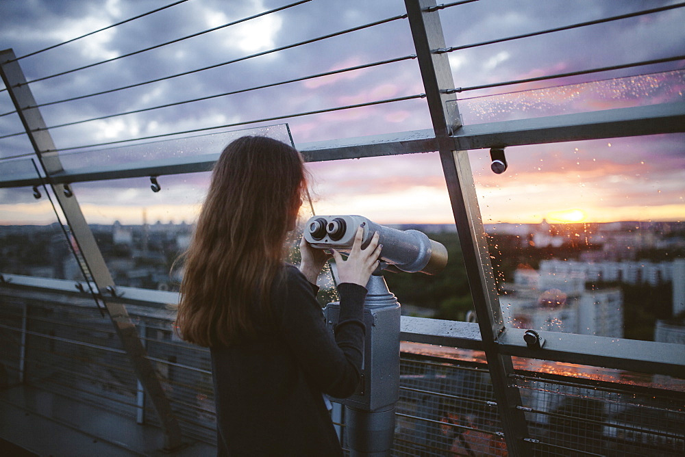 Curious Caucasian admiring scenic view with binoculars