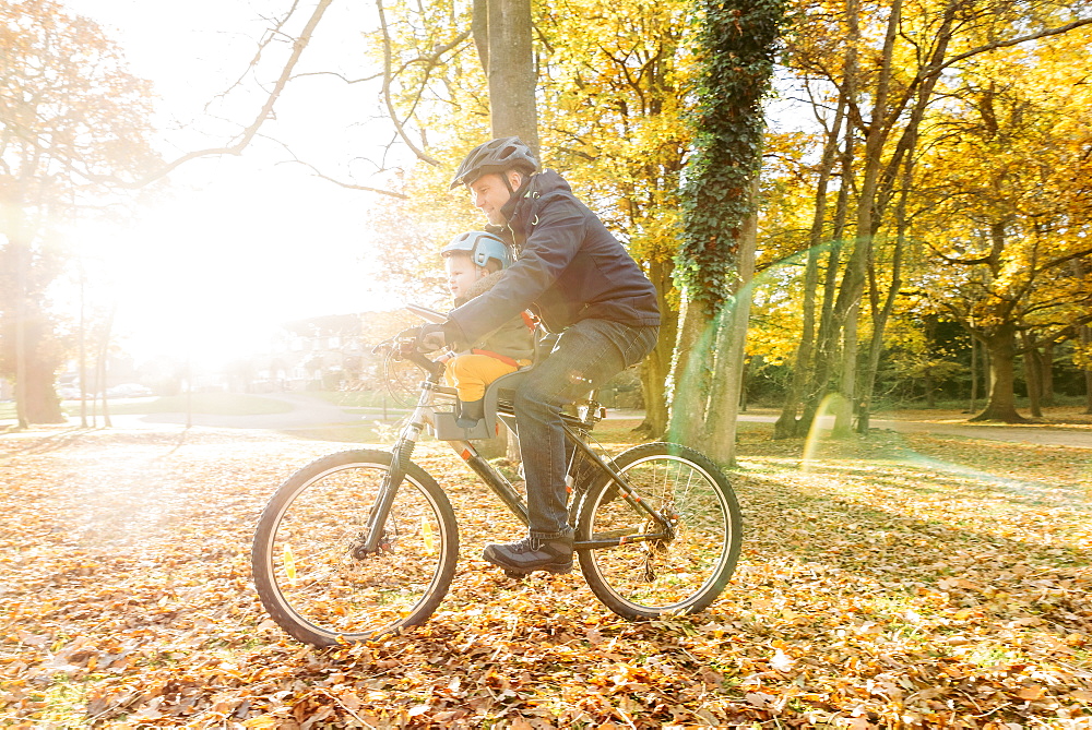 Caucasian father and son riding bicycle