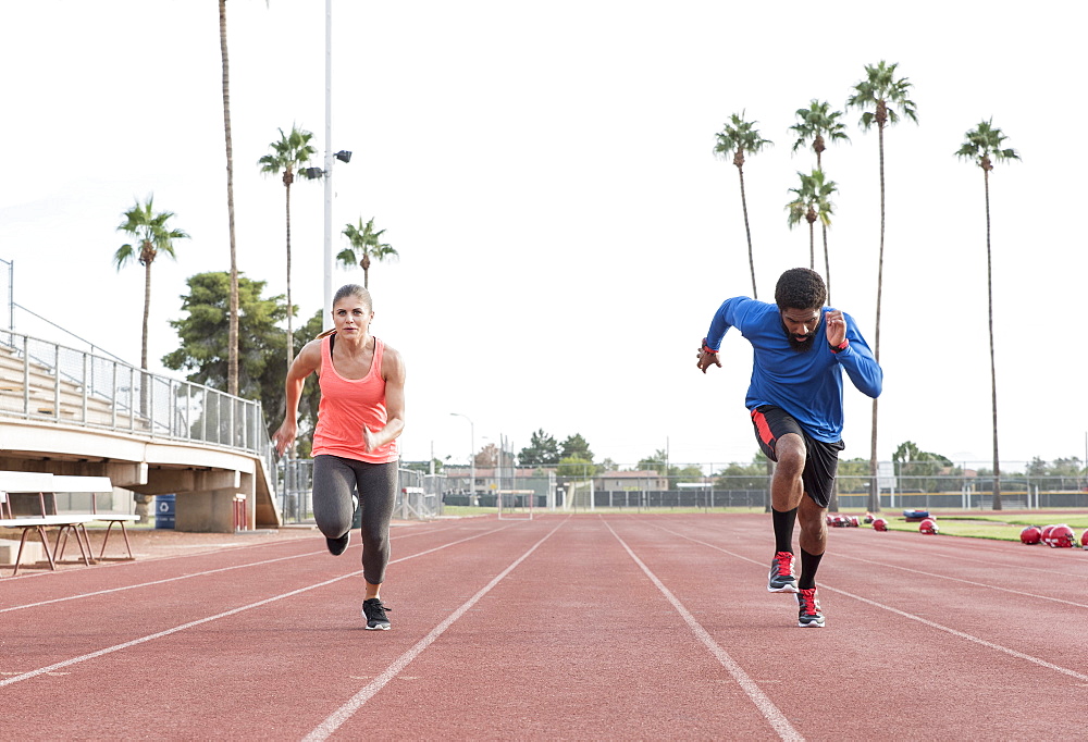 Man and woman running on track