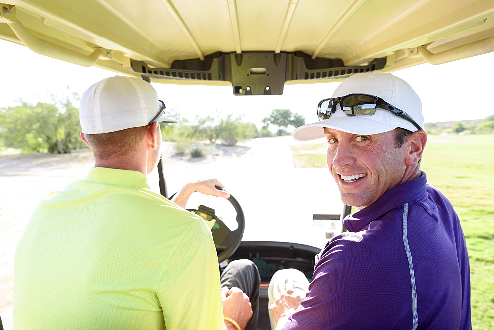 Friends driving on golf course