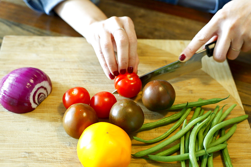 Hands of woman chopping vegetables