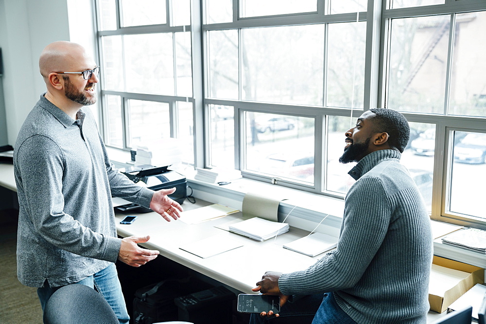 Businessmen talking in office