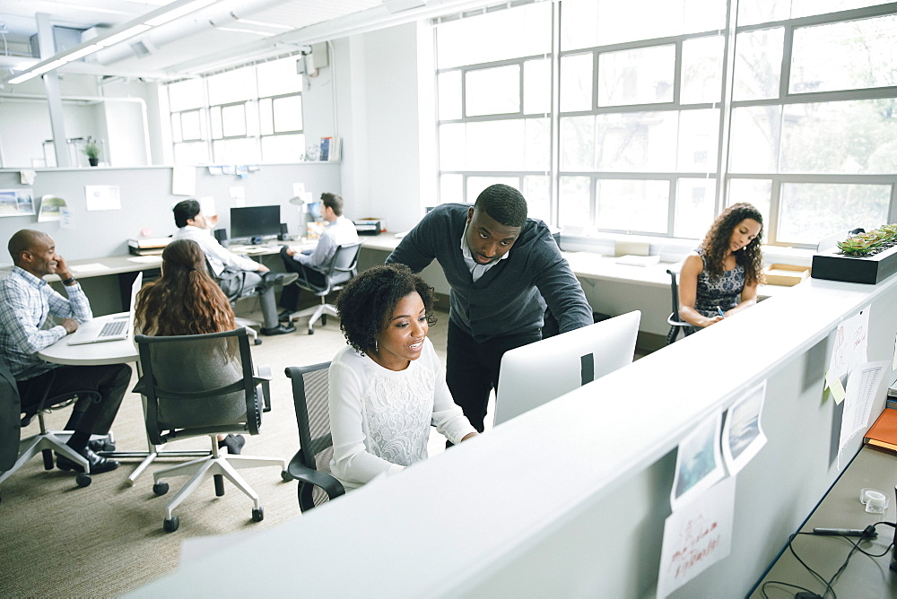 Business people using computer in office