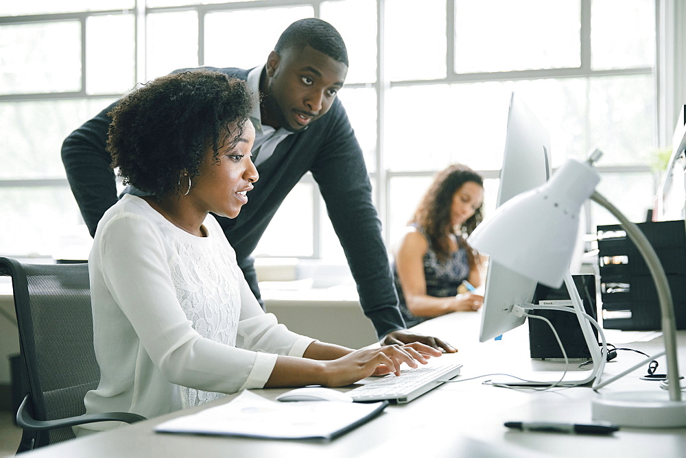 Business people using computer in office