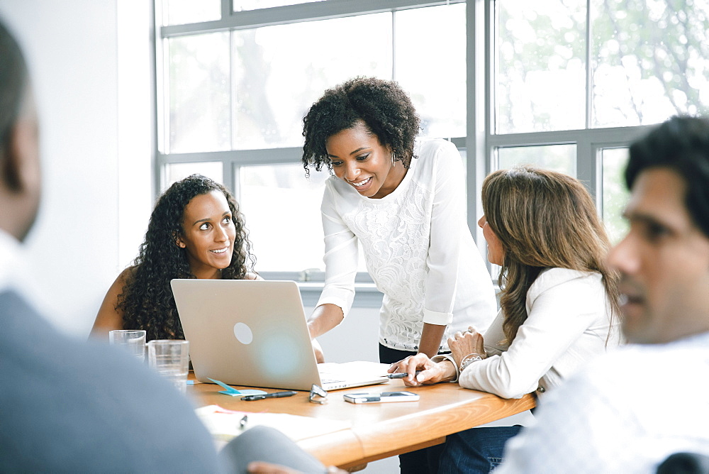 Businesswomen using laptop in meeting