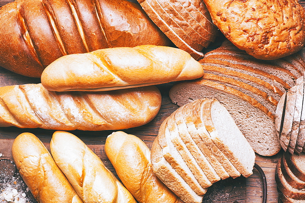 Loaves and sliced bread on table