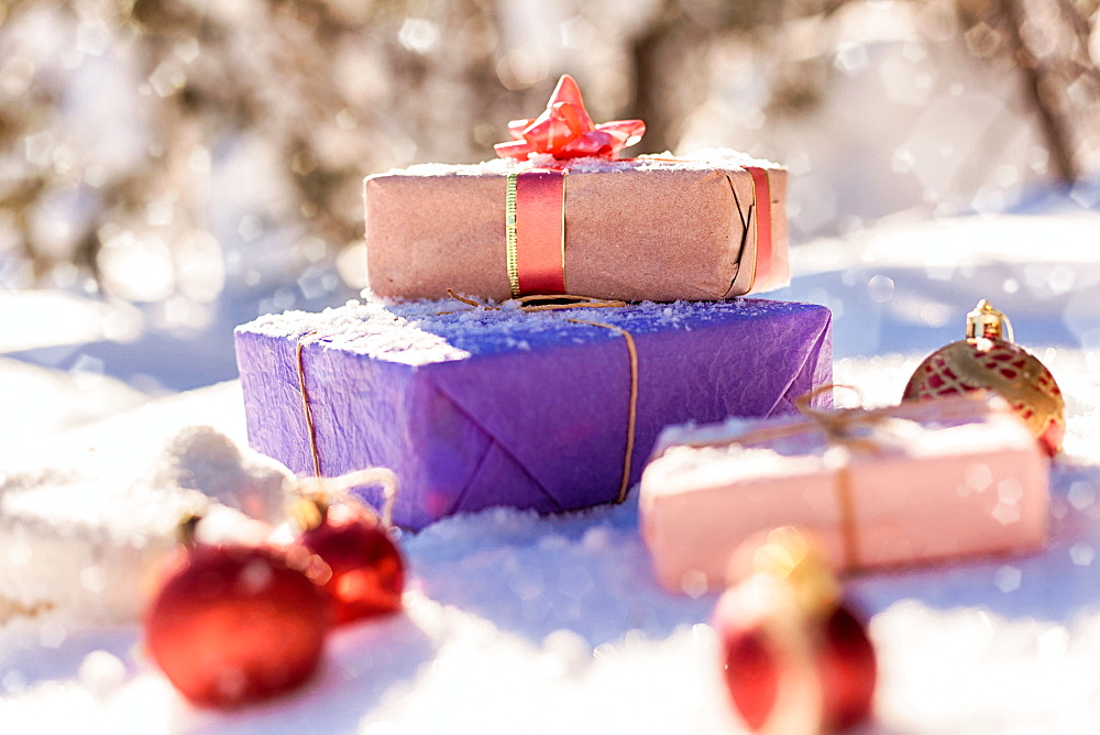 Christmas gifts and ornaments in snow