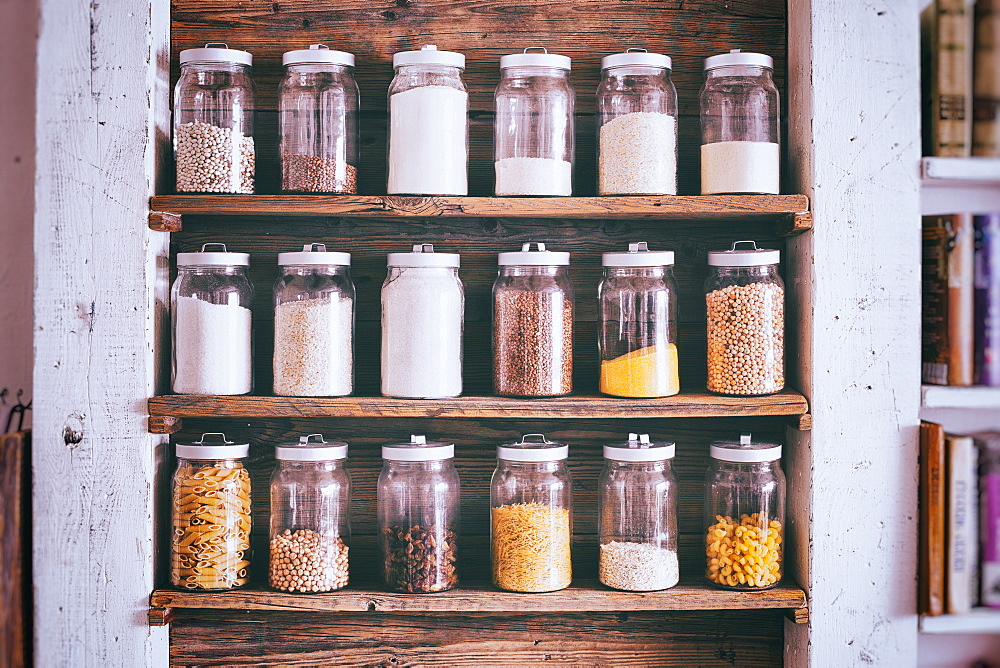 Jars of ingredients on wooden shelves