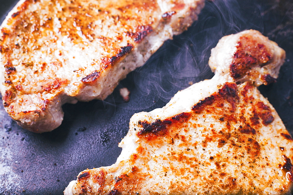 Pork chops searing in pan