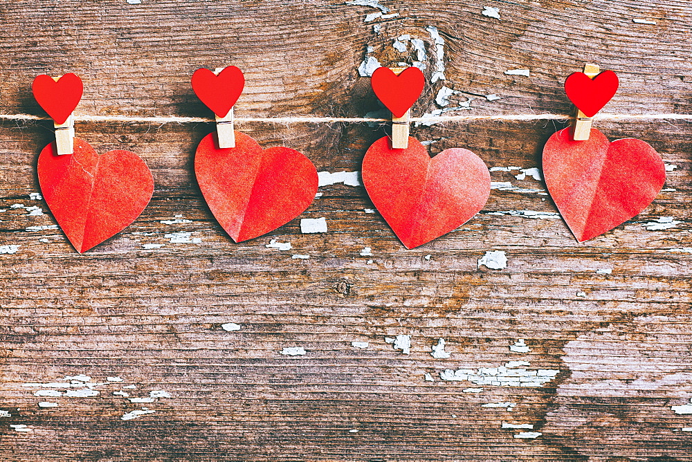 Paper hearts hanging on string with clothespin