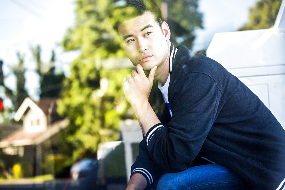 Pensive Chinese man sitting