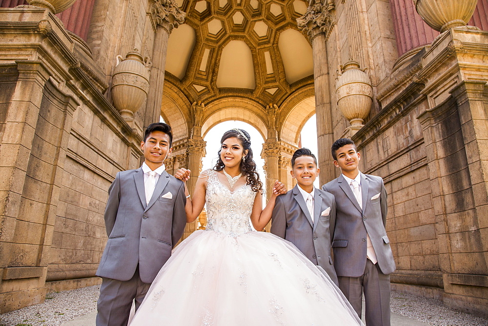 Hispanic girl posing with boys