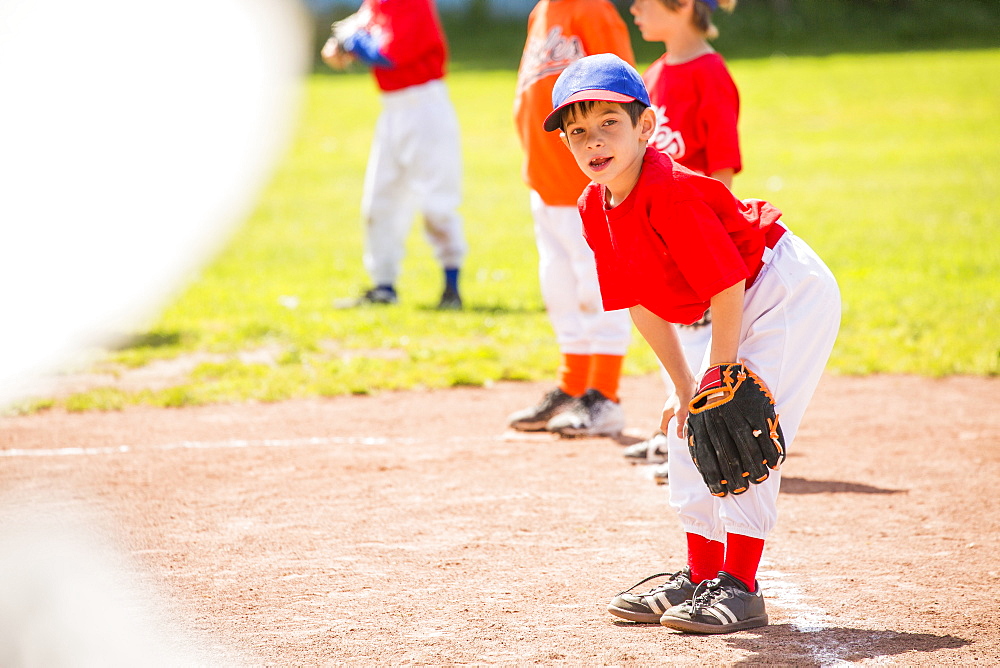 Mixed Race boy playing baseball