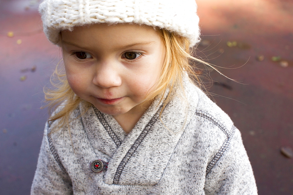 Close up of Caucasian girl wearing sweater and hat