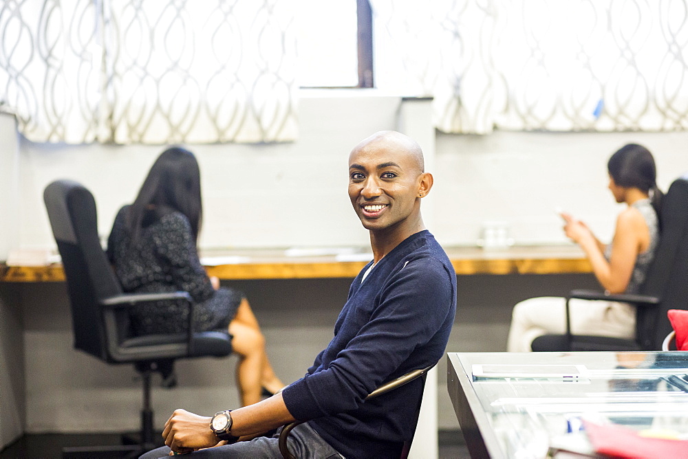 Portrait of smiling African American man sitting in office