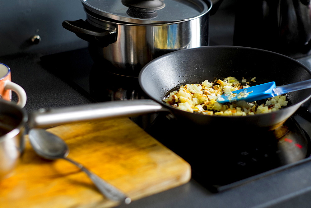 Onions cooking in pan on stove