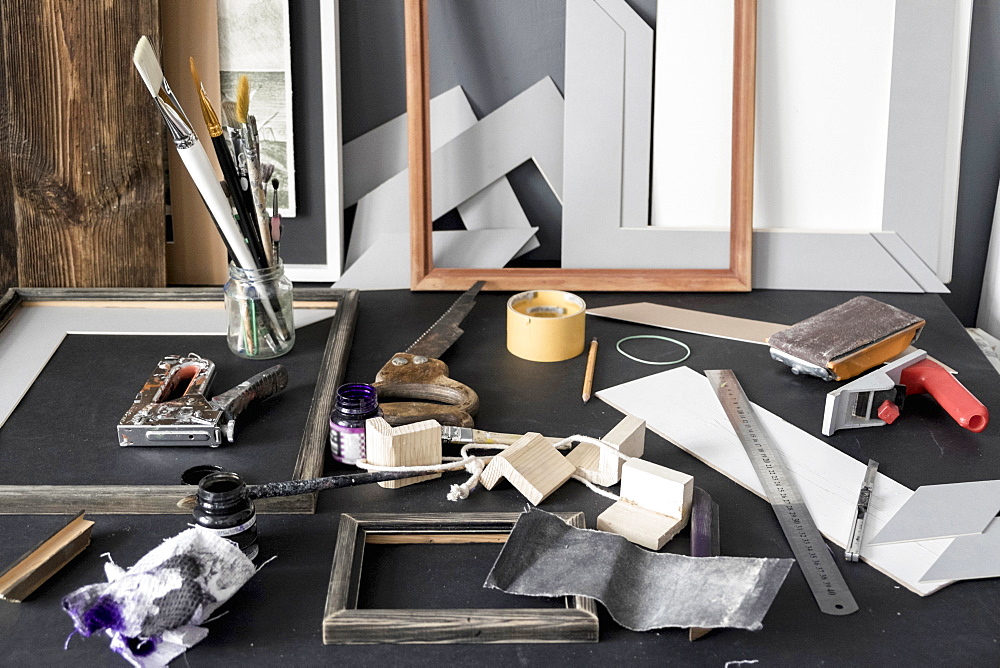 Picture frame and tools on tables