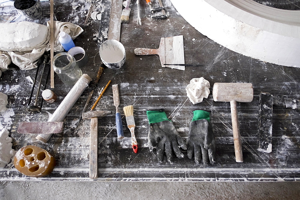 Painting and sculpting tools on messy table